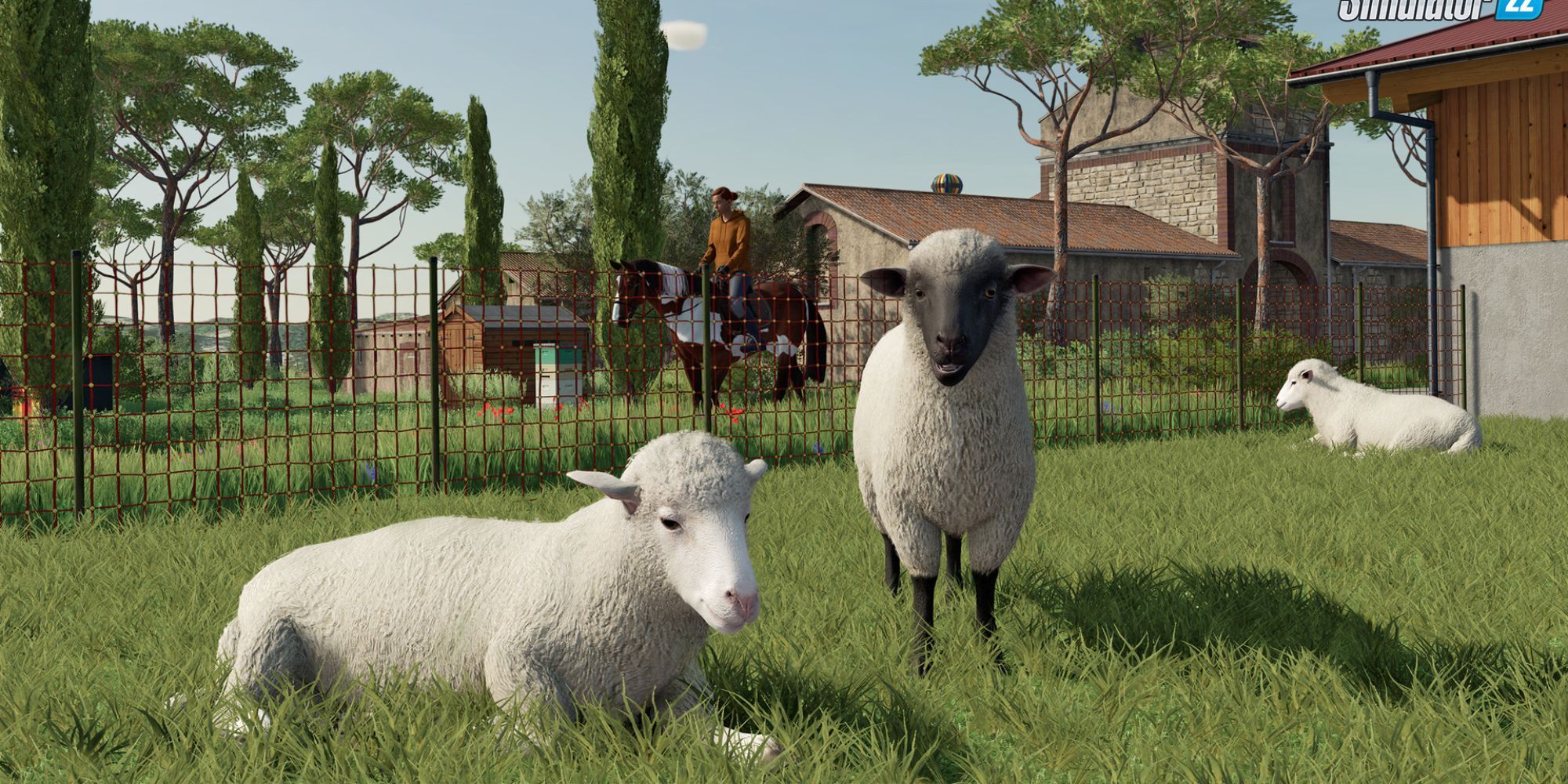 Two sheep resting on the grass in Farming Simulator 22.