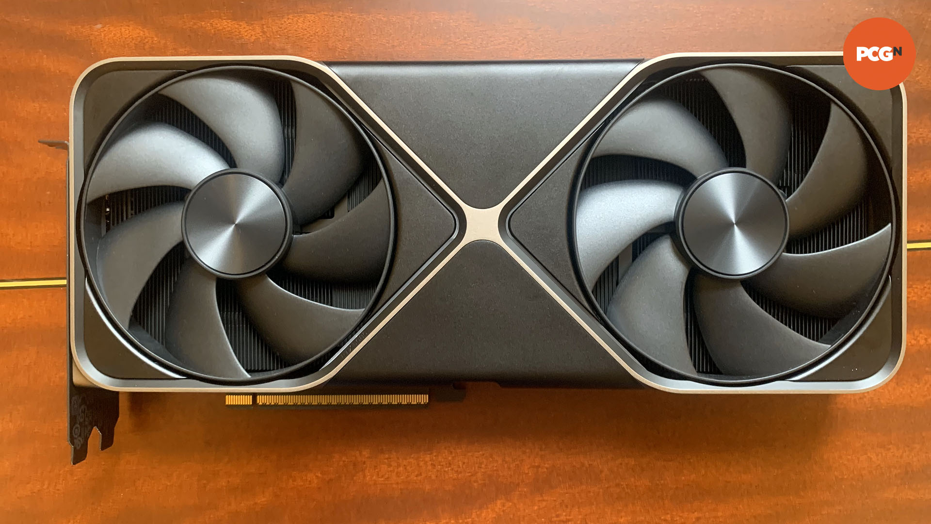 Nvidia GeForce RTX 5080 review: Front of Founders Edition graphics card on wood background.