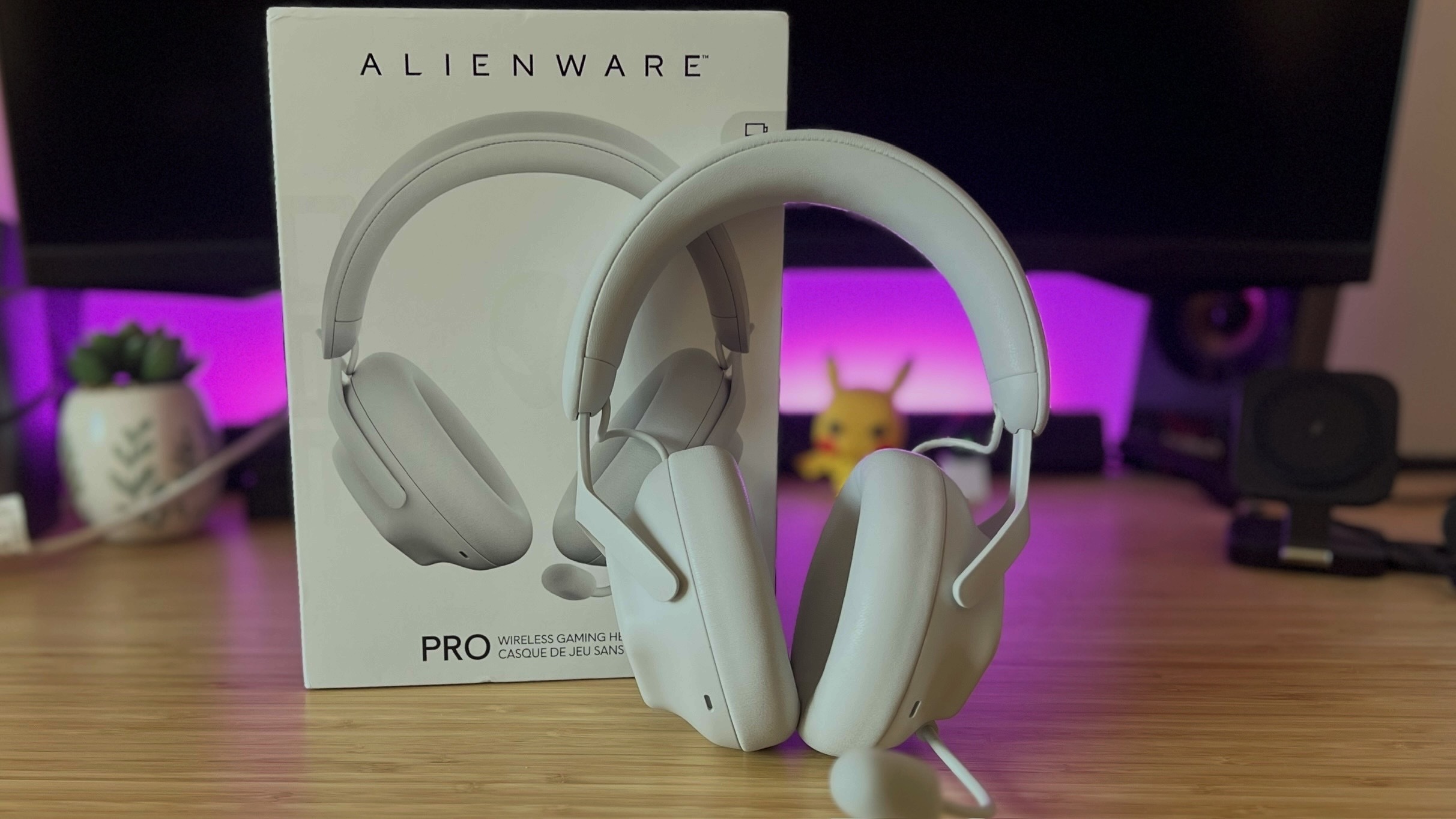 Alienware Pro Wireless headset with packaging on a wooden gaming desk