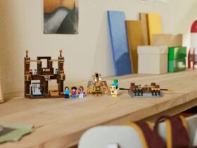 A collection of Lego Minecraft minifigures and scenery laid out on a wooden table