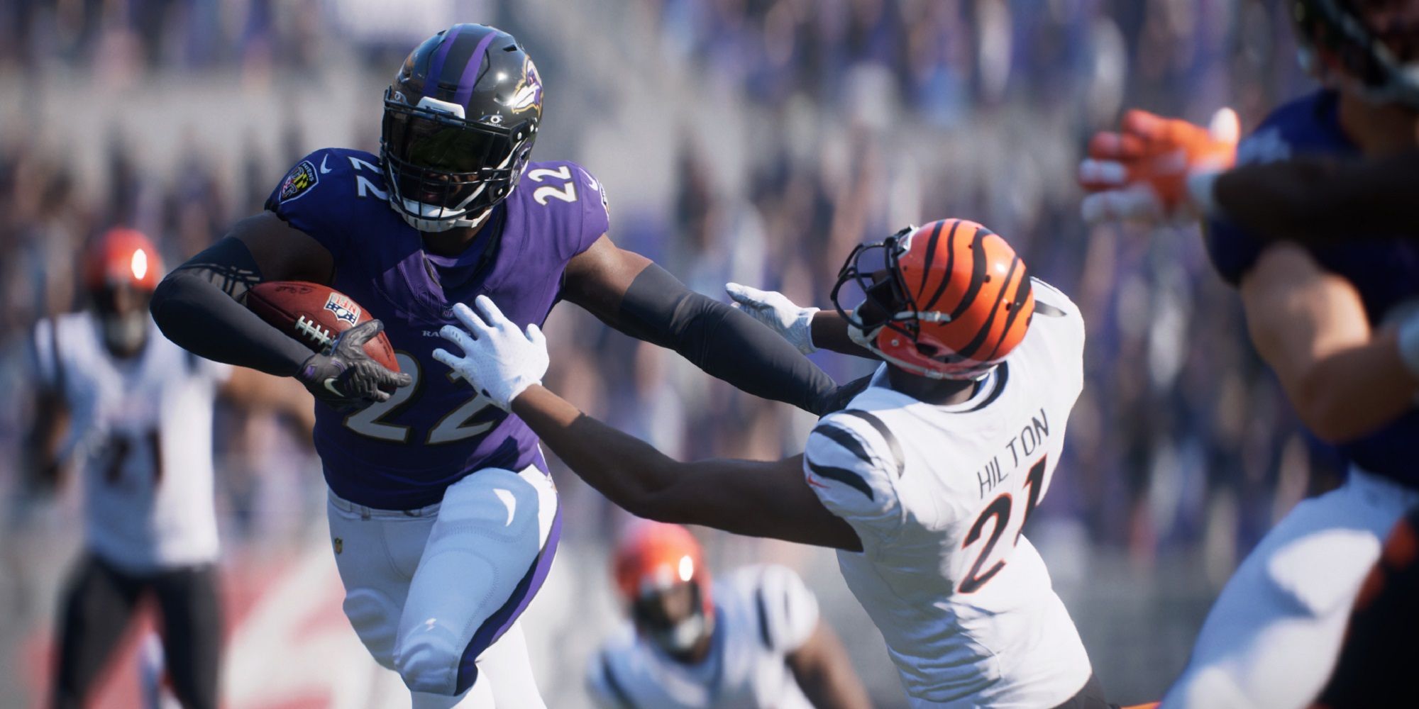 Baltimore Raven's player running with the ball while a Bengals defender trying to stop him