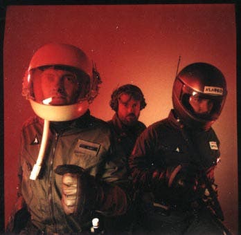 A colour photograph of the Lucasfilm Games Group developers in flight suits and helmets.