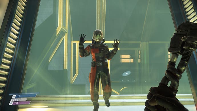 A person in a spacesuit holds up their hands in Prey (2017).