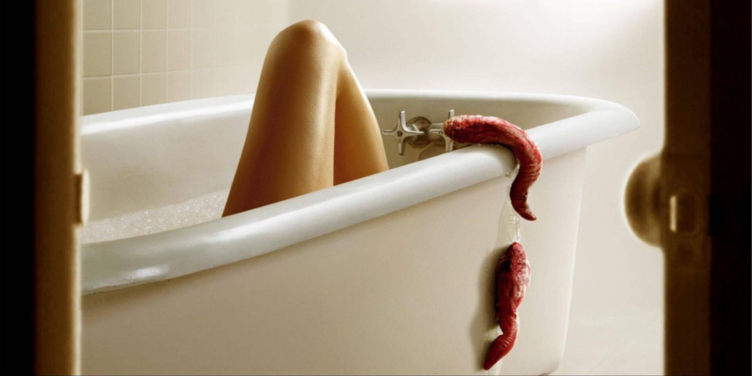 The main art for the movie Slither, with alien parasitic slugs crawling into a bathtub where a leg is seen.