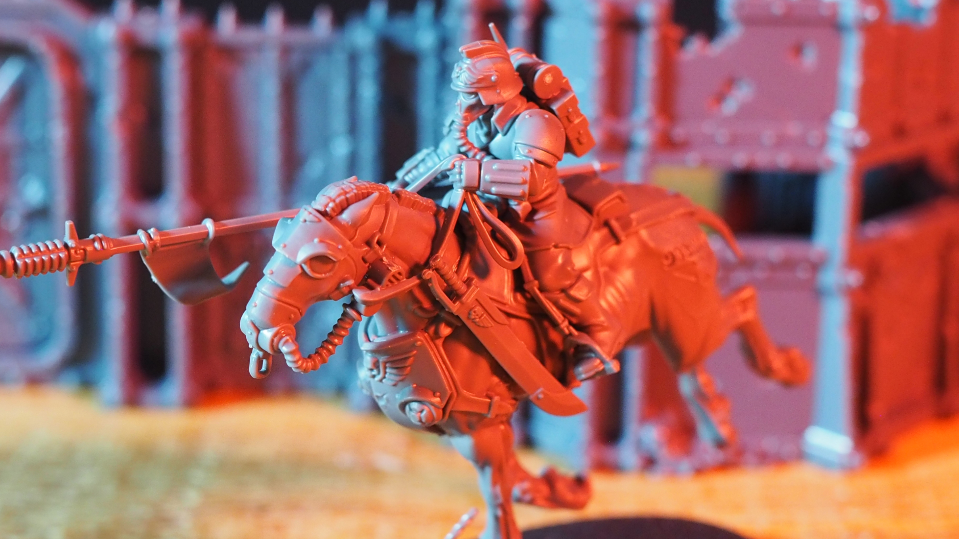 Death Rider in front of model barricades, bathed in red light