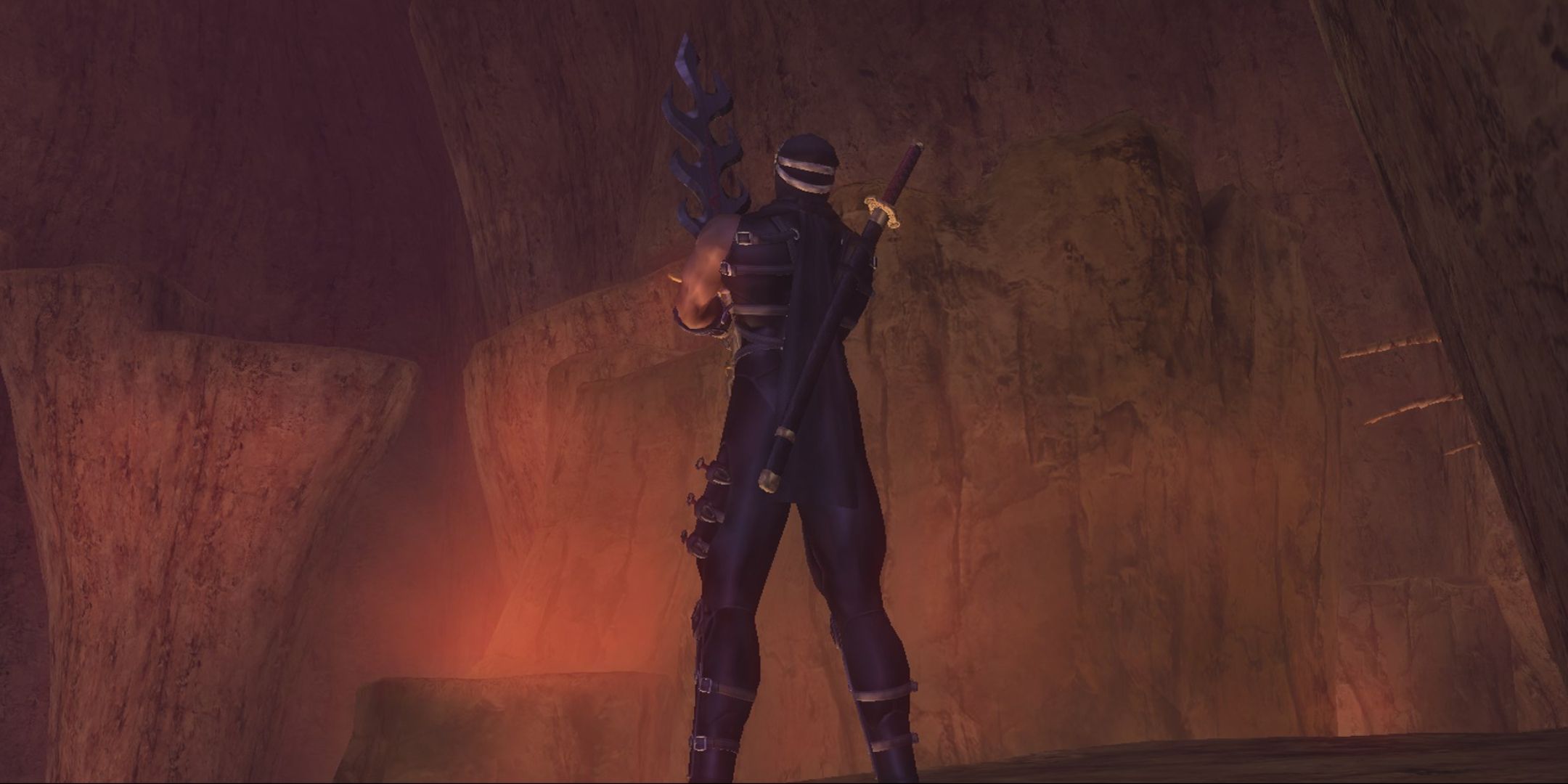 Ryu from Ninja Gaiden Black posing with his arm crossed in a volcanic area.