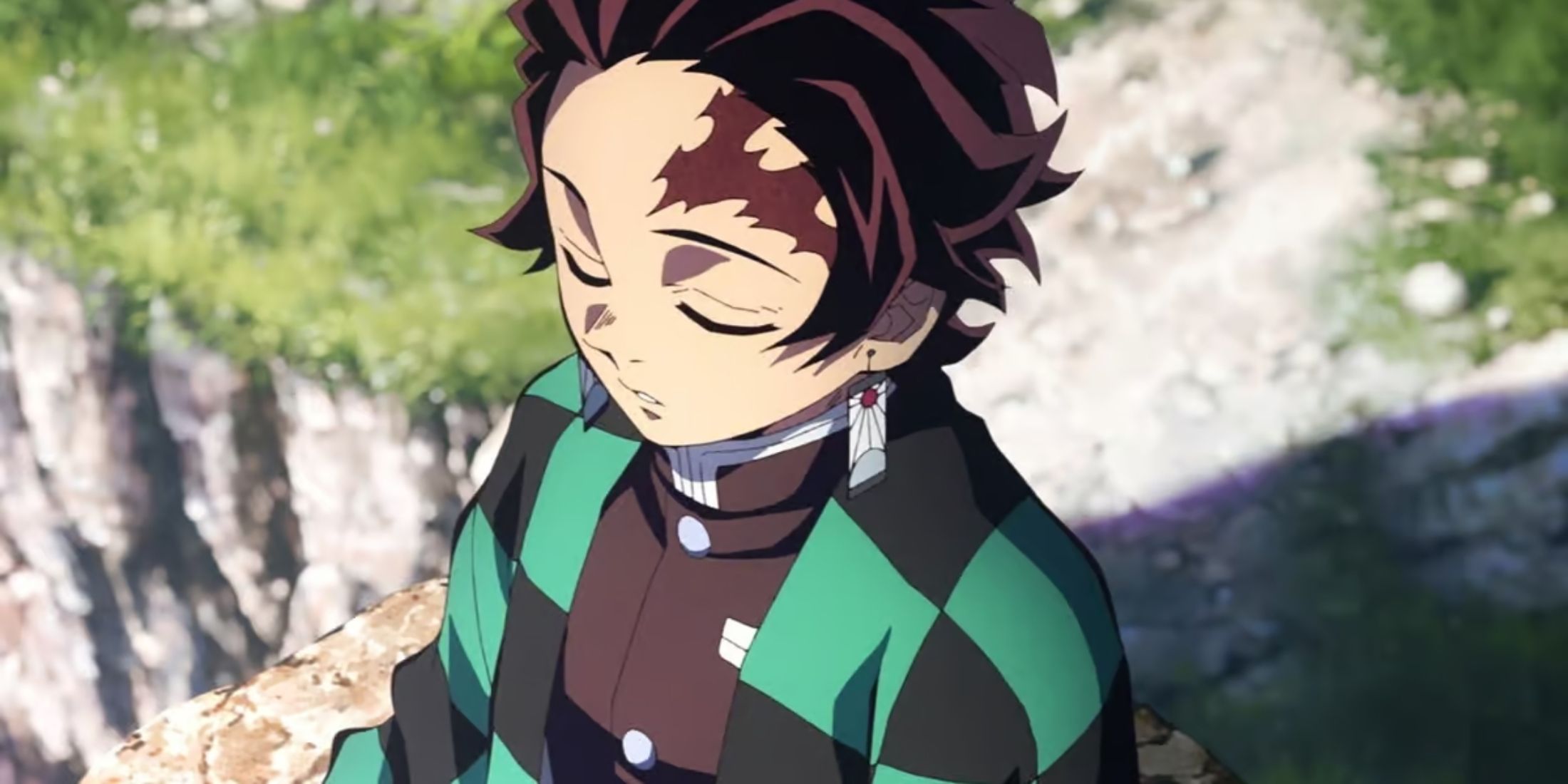 Tanjiro Kamada meditating on a cliffside