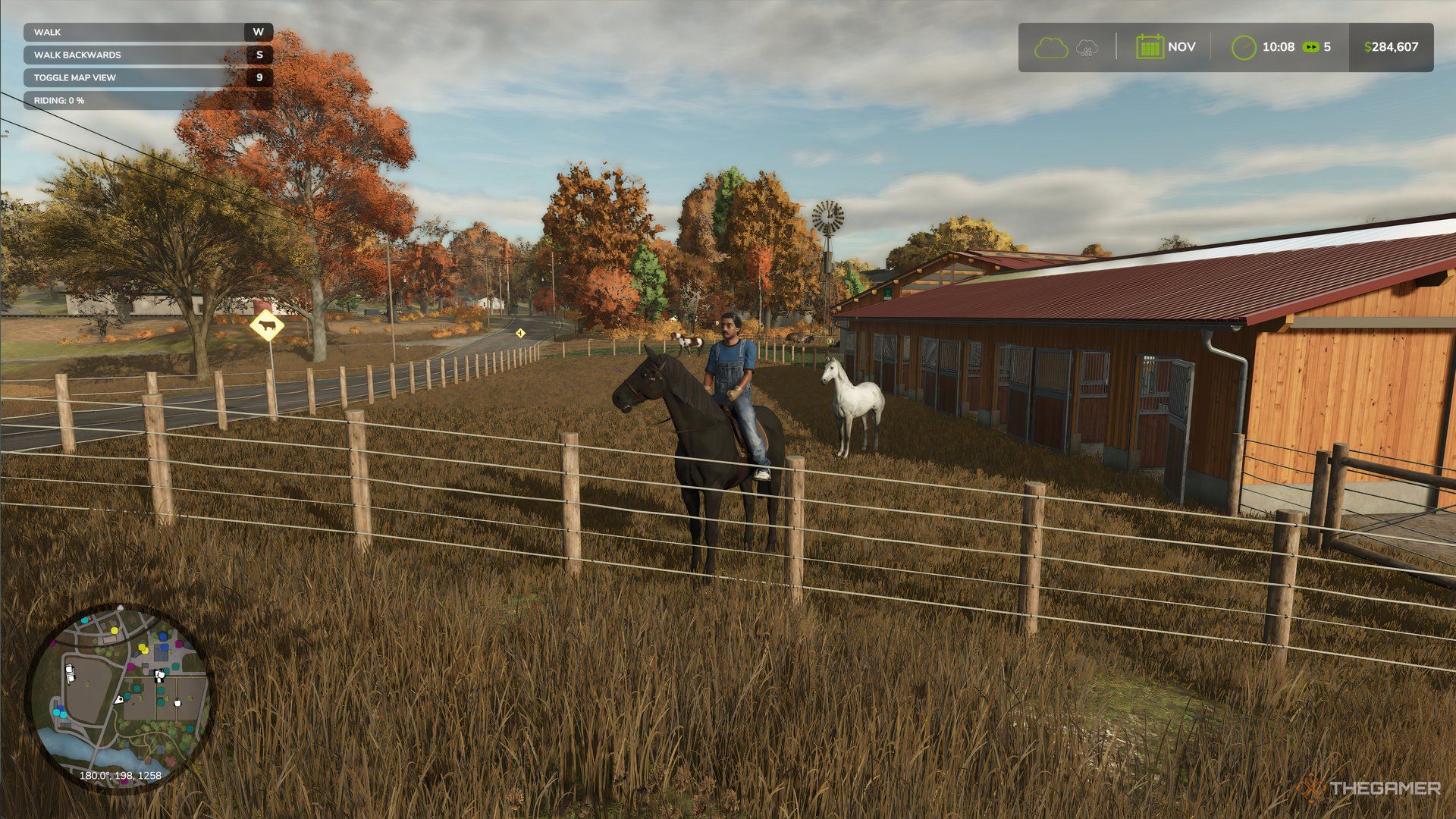 A man riding a black horse in Farming Simulator 25. There is also a white horse in the background.