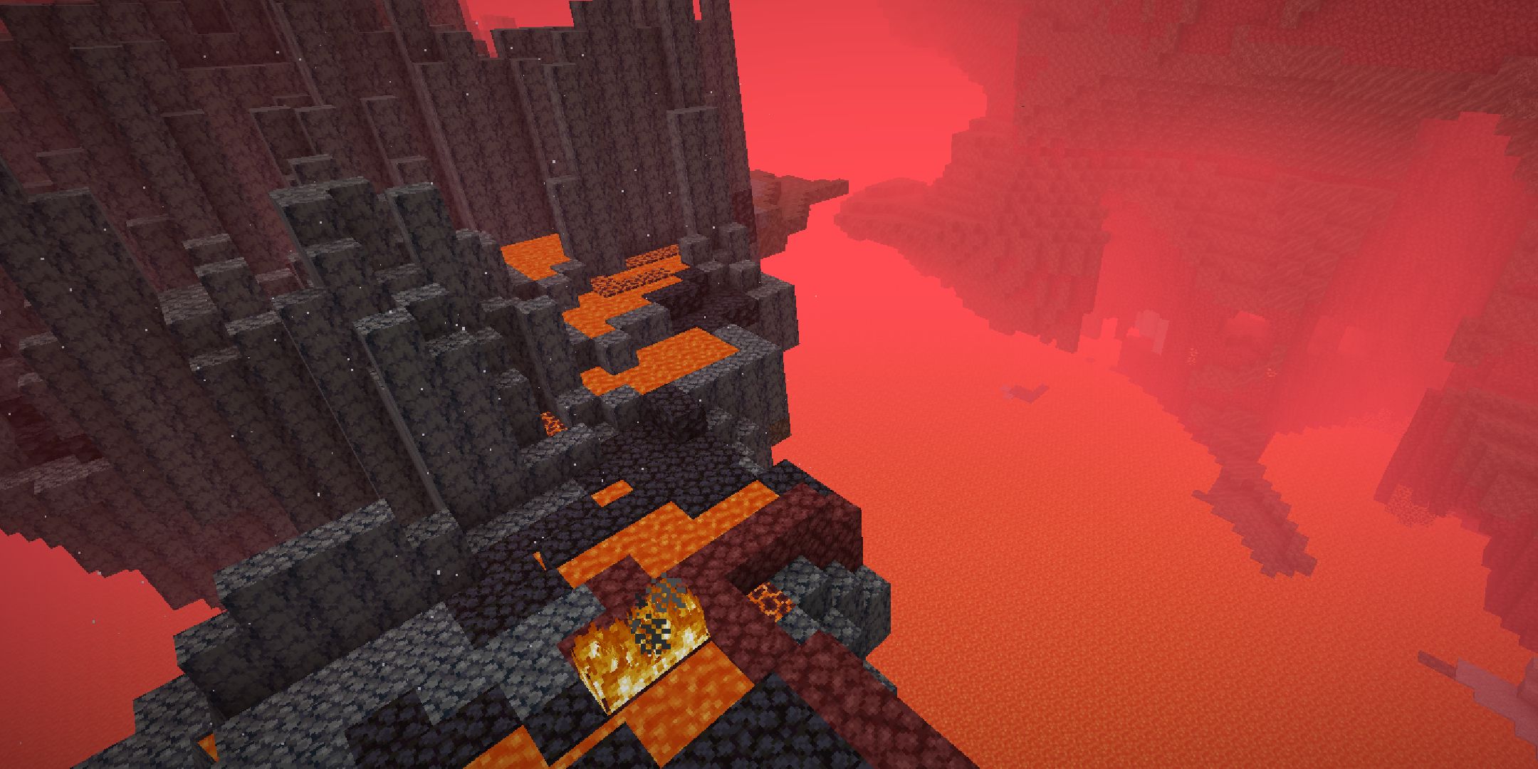 The Nether from a high angle showing fire and lava.