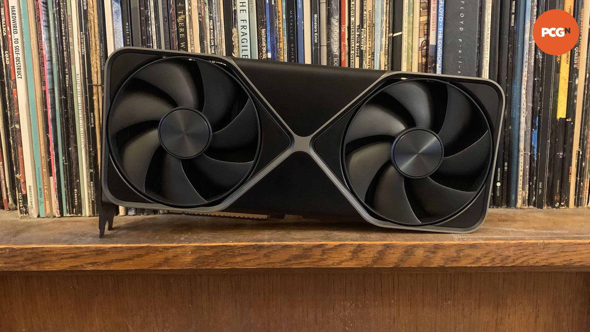 Nvidia GeForce RTX 5080 review: front of Founders Edition graphics card on book shelf.