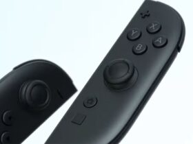 The new Nintendo Switch 2 Joy-Cons on a white background. They're black with some pops of colour around the sticks, and there's a new button under the home button