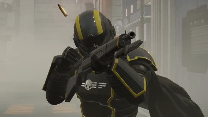 Close up of a Helldiver character in black and yellow armour aiming a rifle