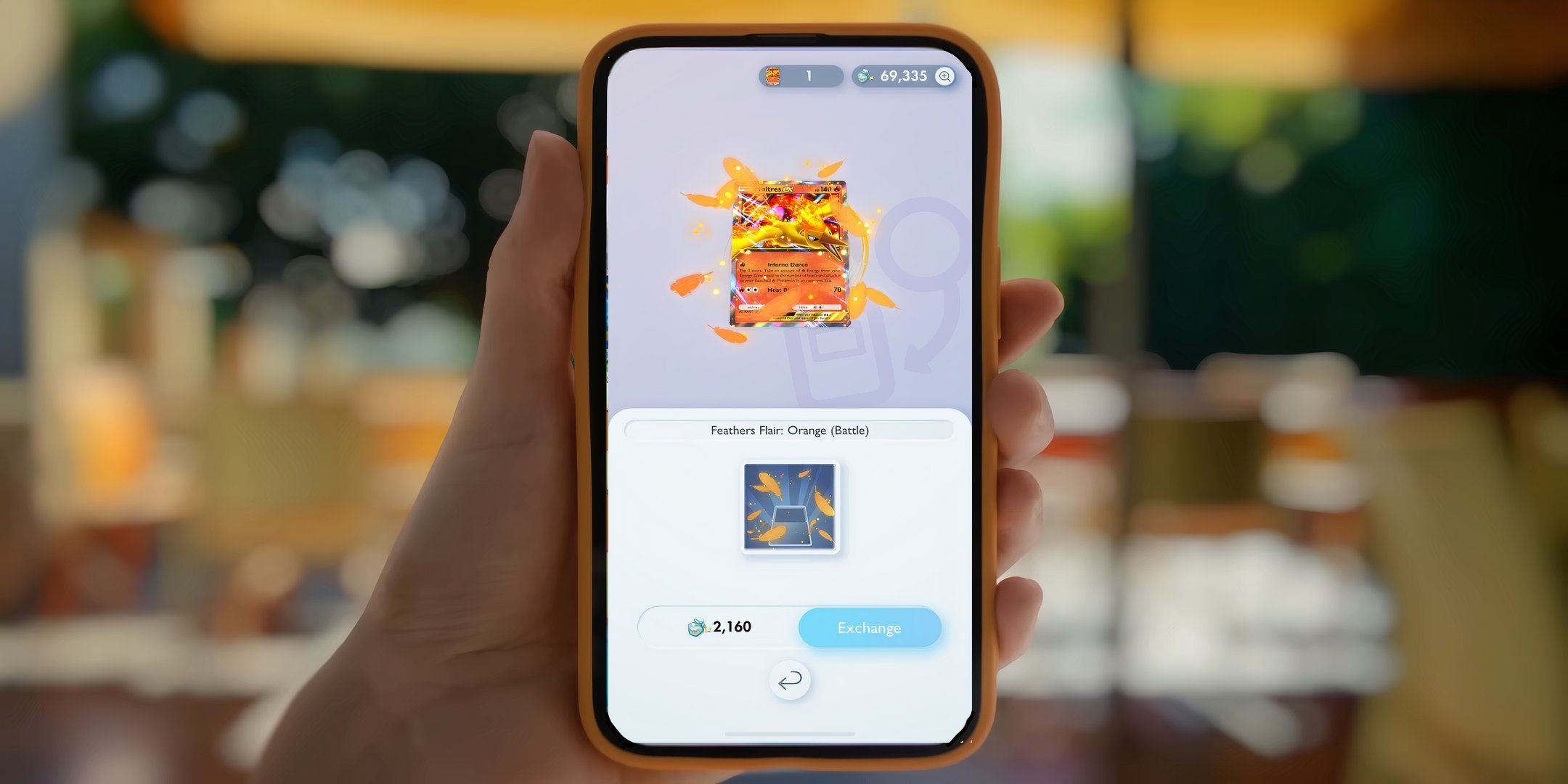 Pokémon TCG Pocket player holding phone with moltres ex flairs