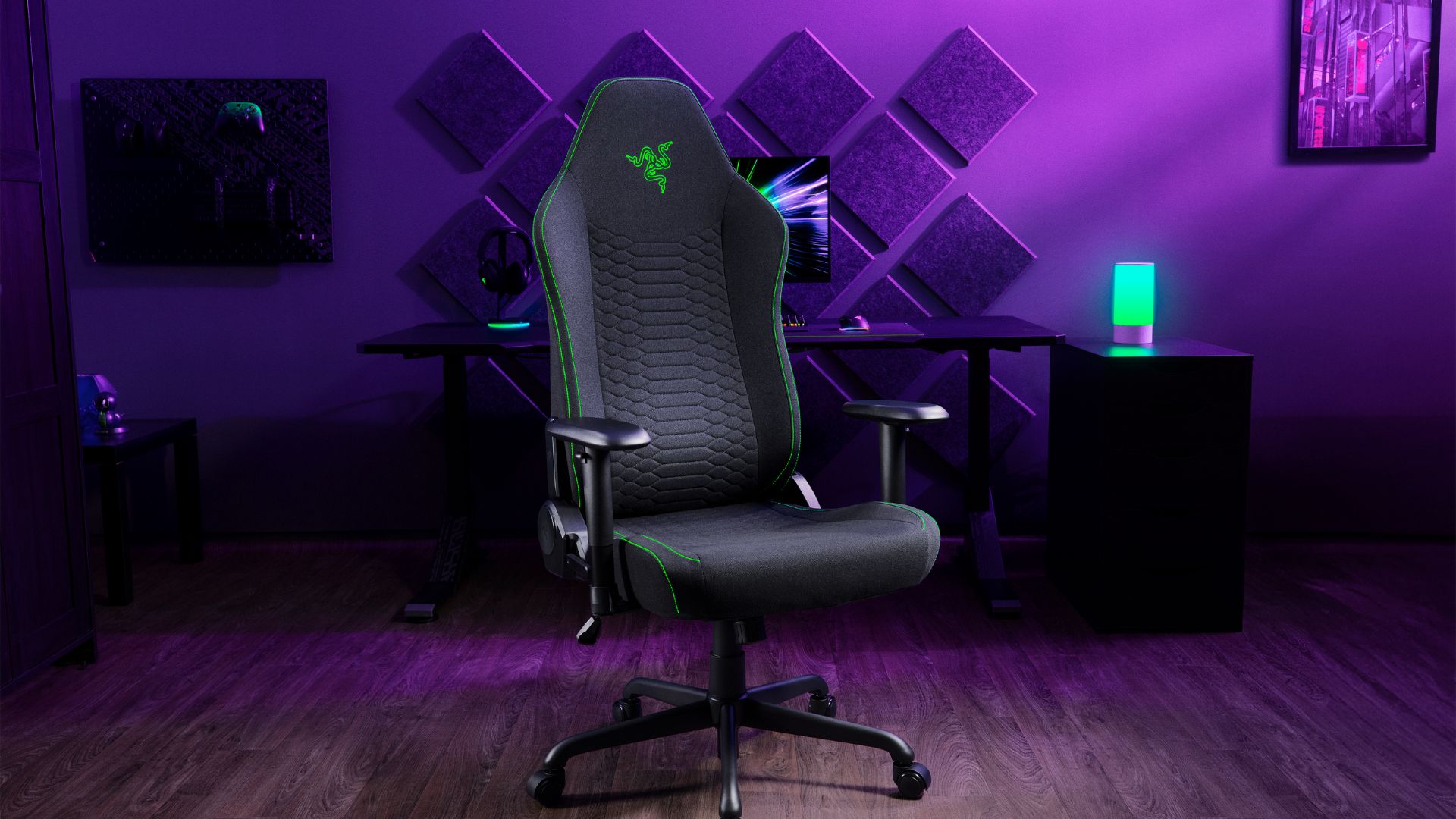 A Razer Iskur V2 X in front of a purple-lit gaming space