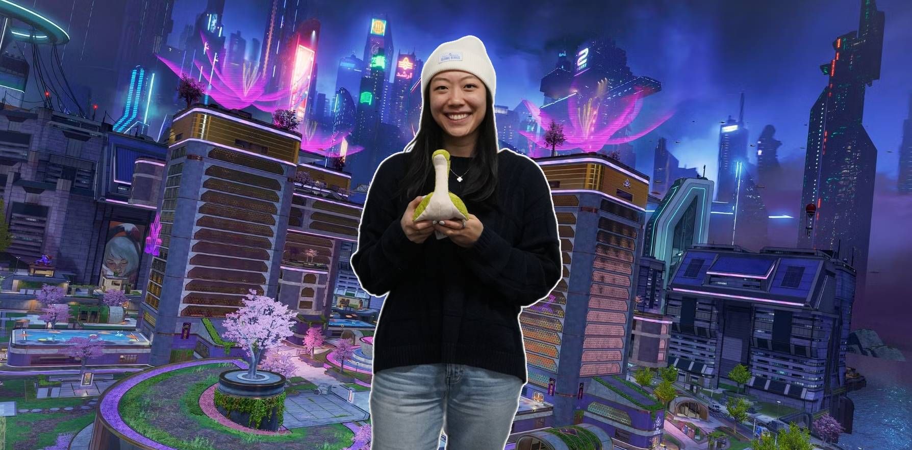 EA's Jasmine Chiang holding a Nessy in front of Apex Legends' eDistrict map