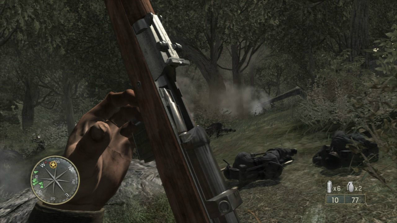 Call of Duty 3 screenshot of a character reloading s gun in a dark woodland