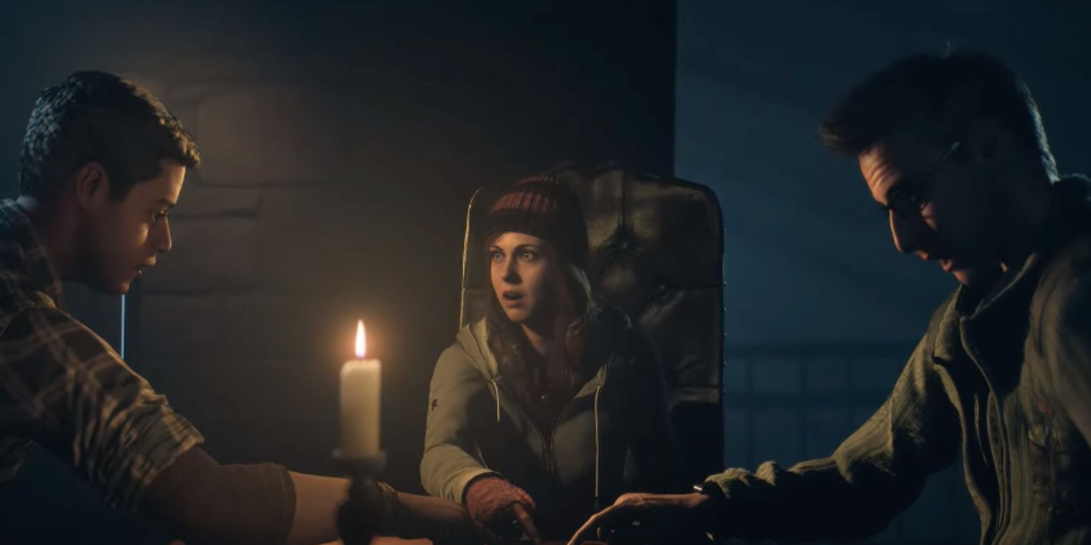 Ashley, Josh, and Chris performing a seance in the lodge in Until Dawn