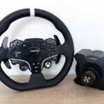 The Moza R3 racing wheel next to its wheelbase