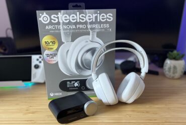 SteelSeries Arctis Nova Pro Wireless in white with packaging and hub on a wooden desk