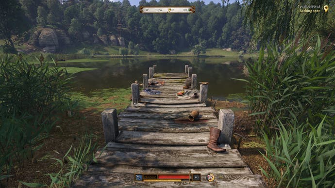 A wooden jetty extends out to a lake in Kingdom Come Deliverance 2. The jetty is strewn with discarded clothes and picnic items.