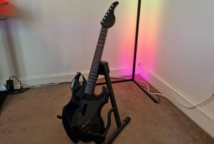 PDP Riffmaster preview image of the guitar on a stand in front of an RGB corner lamp