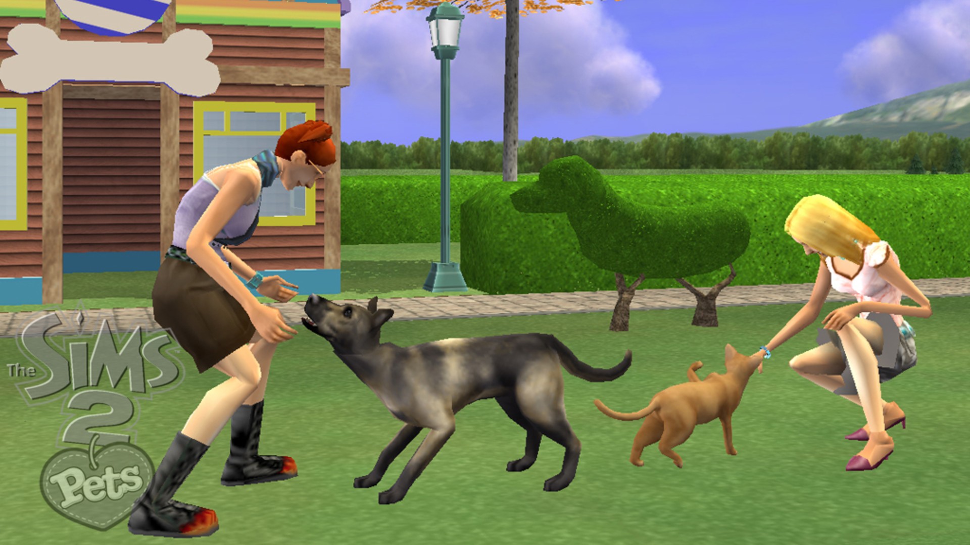 The Sims 2 Pets screenshot from Nintendo Wii depicting two sims playing with dogs outside in a grassy garden