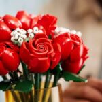 Lego Bouquet of Roses in a vase, with a hand taking one