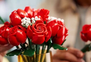 Lego Bouquet of Roses in a vase, with a hand taking one