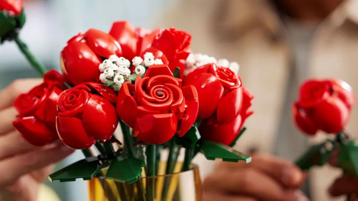 Lego Bouquet of Roses in a vase, with a hand taking one