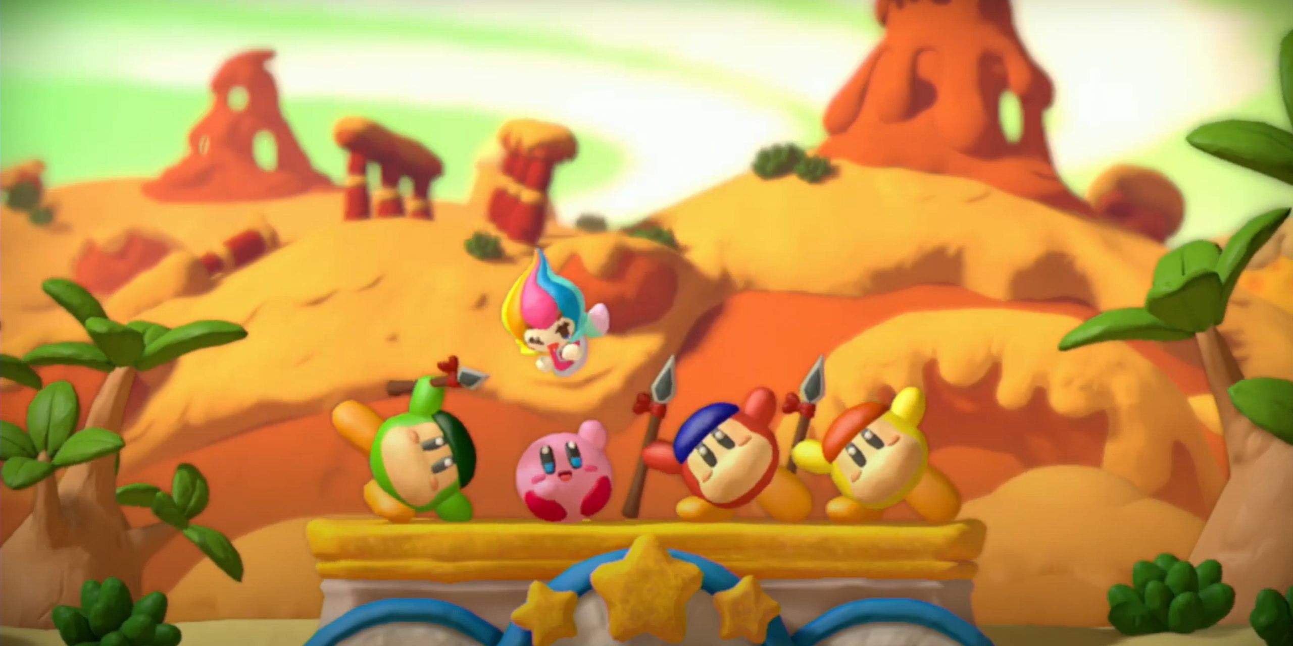 Kirby, Elline, and three Waddle Dees in a desert from Kirby and the Rainbow Curse.