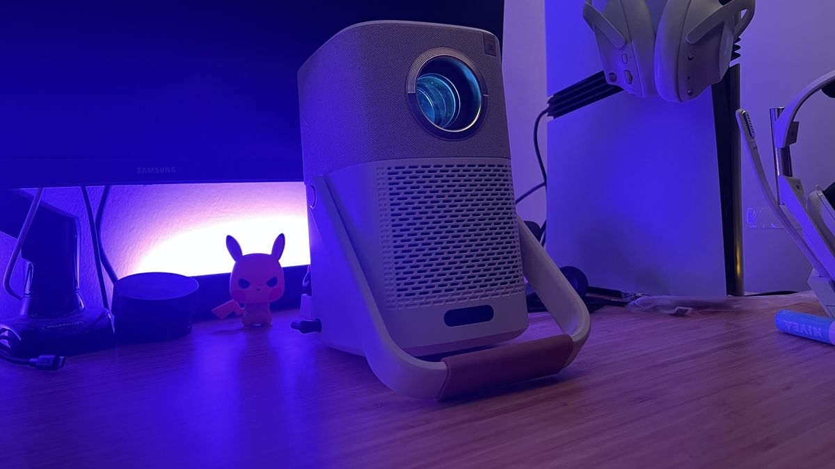 Yaber T2 projector running on a wooden desk with PS5 Pro