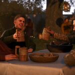 Kingdom Come: Deliverance 2 screenshot showing a group of medieval men sitting at a table with food, cheering together with wooden mugs of beer lifted high