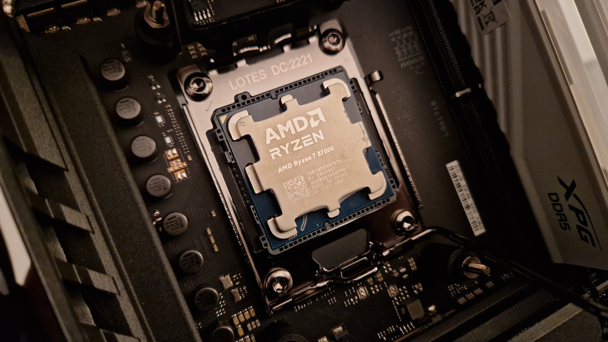 An AMD Ryzen 7 8700G seated on a motherboard