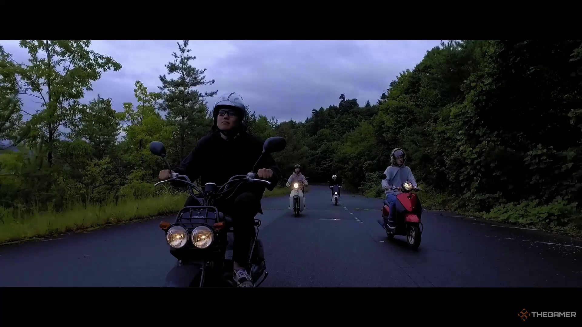 Members of Don Yasa Crew riding motorbikes on a road.