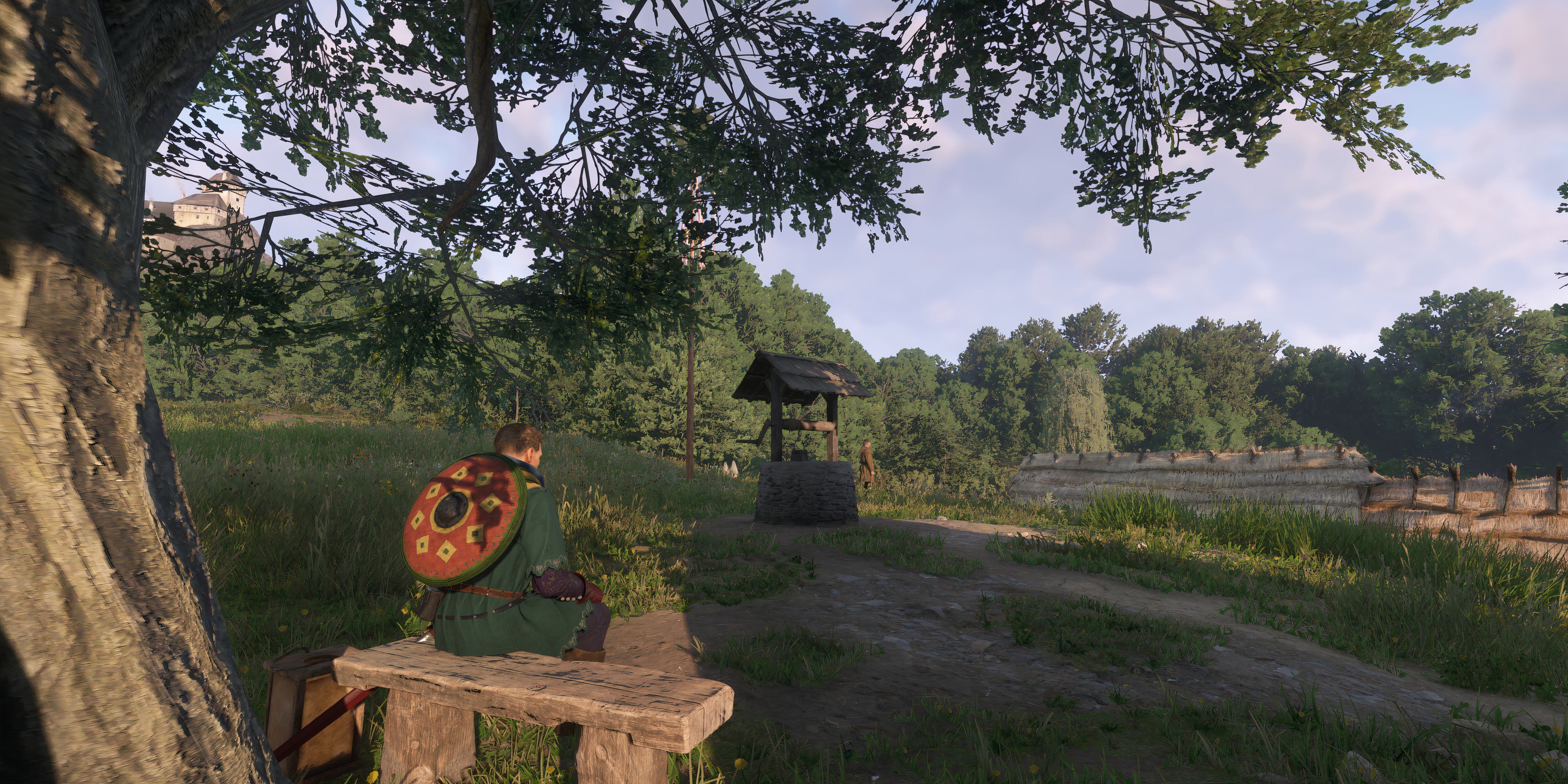 A picture of the player sitting on a bench near a well - kingdom come deliverance 2