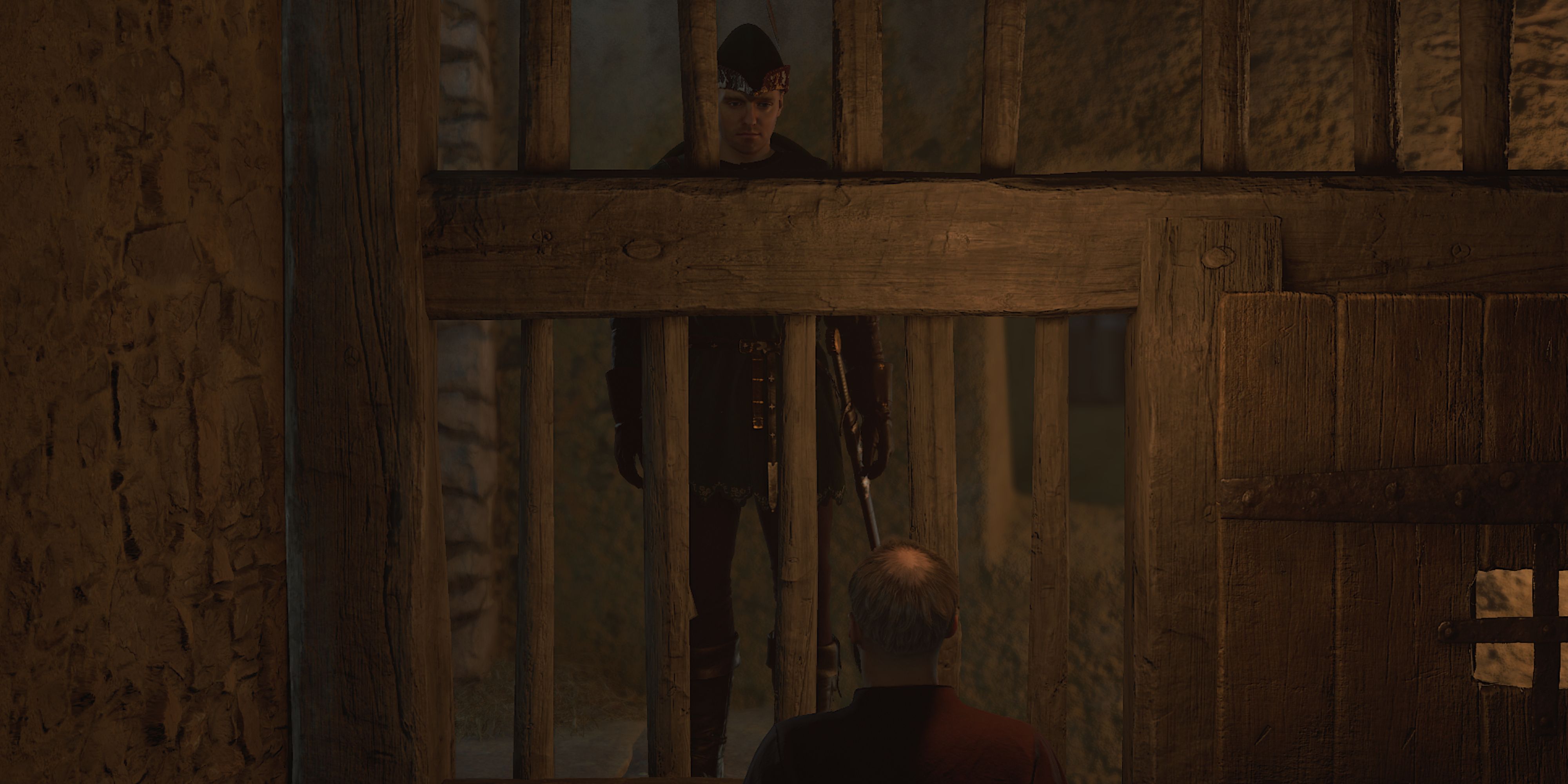 The player is speaking to a prisoner behind the cell - Kingdom Come Deliverance 2