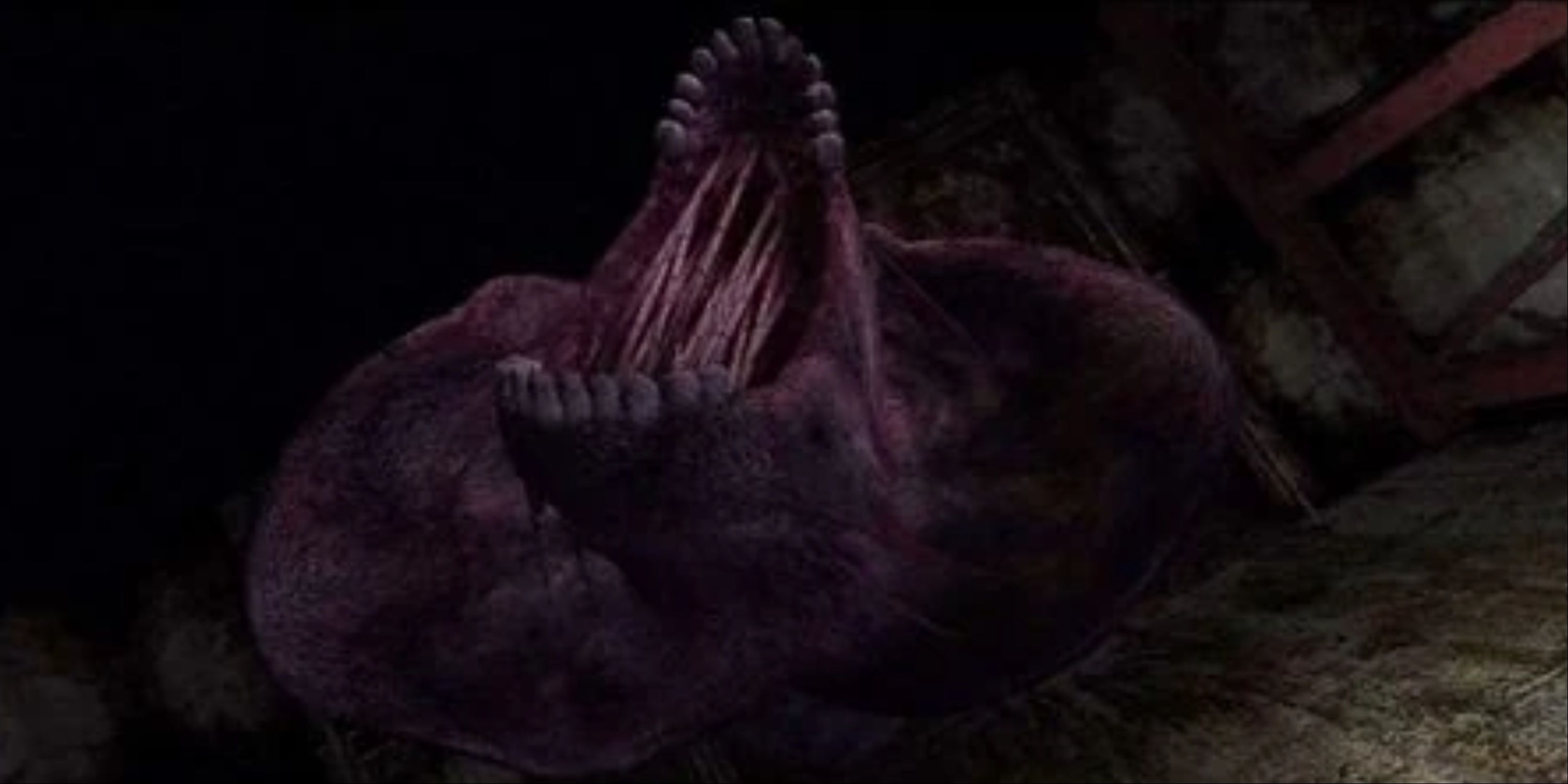 A giant purple worm with human teeth.