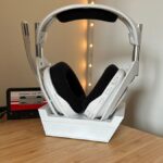 Astro A50 X headset in dock on a wooden table