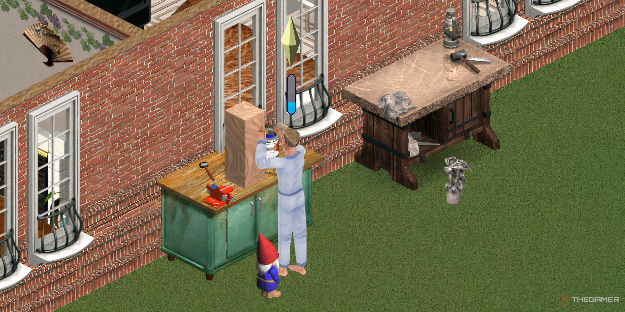 A Sim making gnomes next to a gargoyle on the floor.