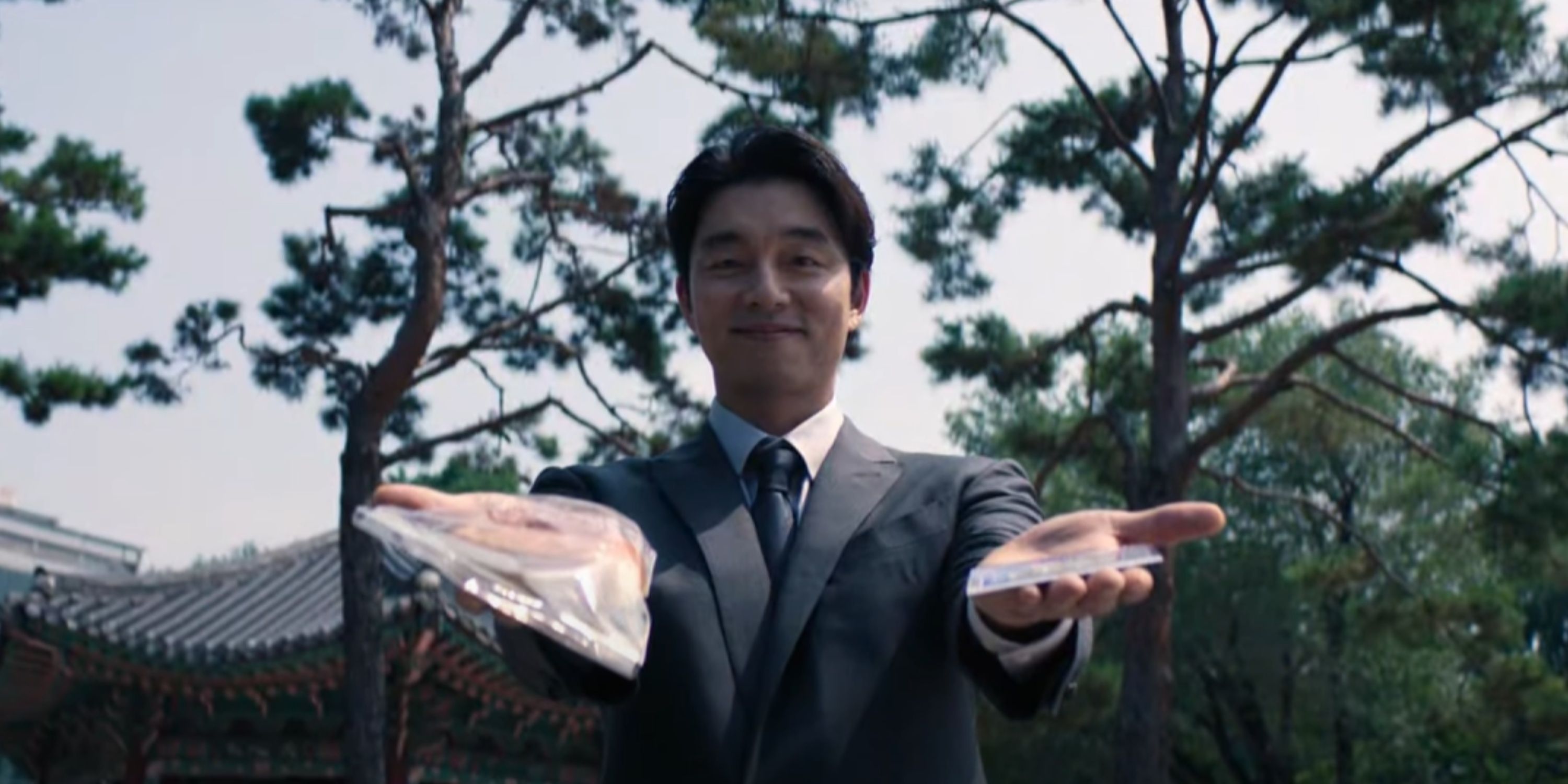 The Recruiter smiles as he offers bread or a lottery card.