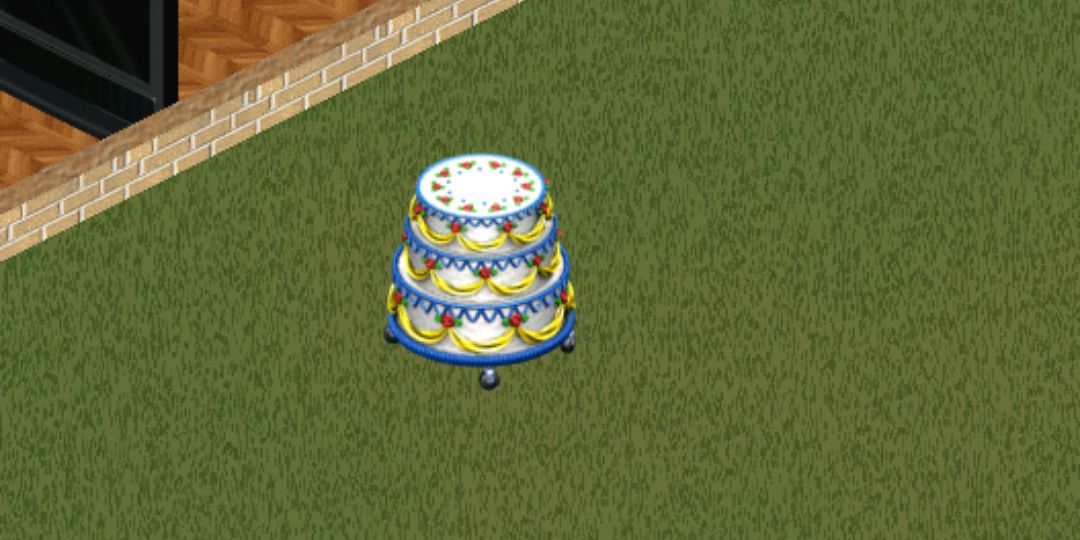 A cake sits on a set of wheels in the backyard.