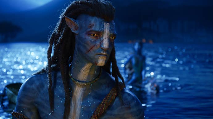 Jake Sully stood at a lake at night time in Avatar: The Way of Water.