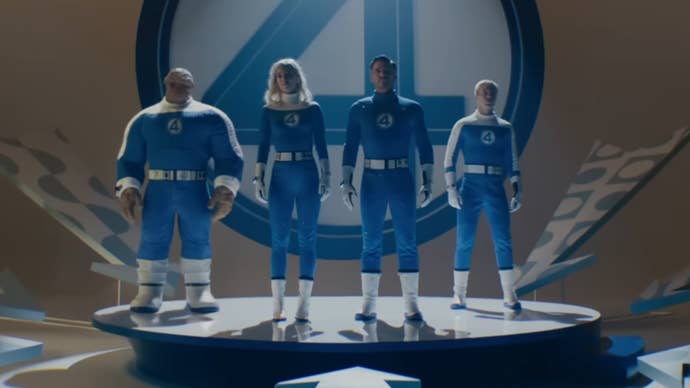 The titular Fantastic Four in First Steps all lined up on a stage wearing '60s era blue superhero costumes.