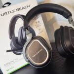 Photo taken by writer Rosalie Newcombe of the Turtle Beach Stealth 700 Gen 3 gaming headset sitting on top of a black PC tower with its box behind it.