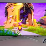 Philips Evnia 42M2N8900 monitor with Spyro the Dragon gameplay on screen