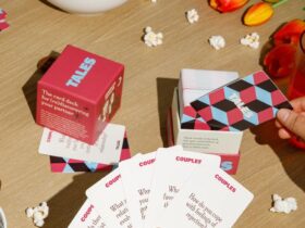 The Tales card game being played on Valentines day with flowers and chocolate surrounding the scene