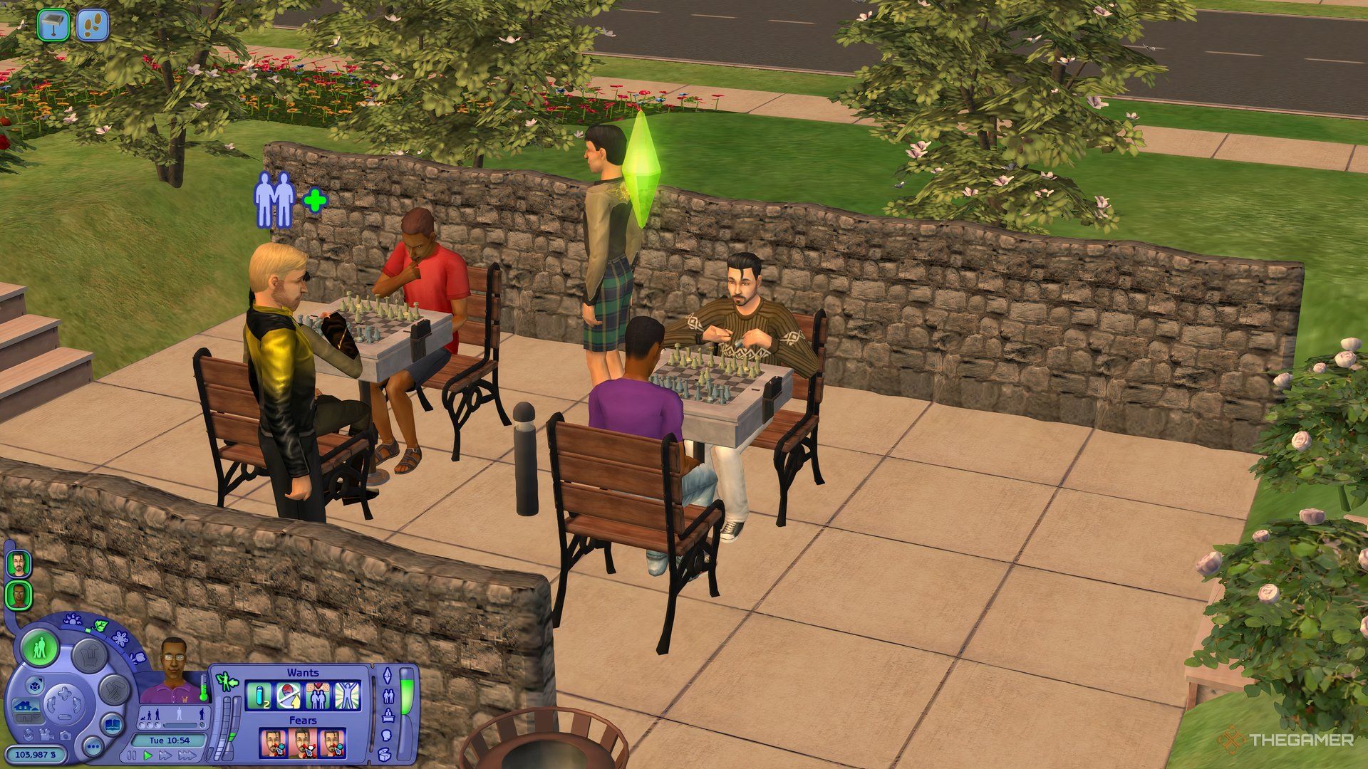 A group of Sims in the park in Pleasantview playing chess together, including a couple.