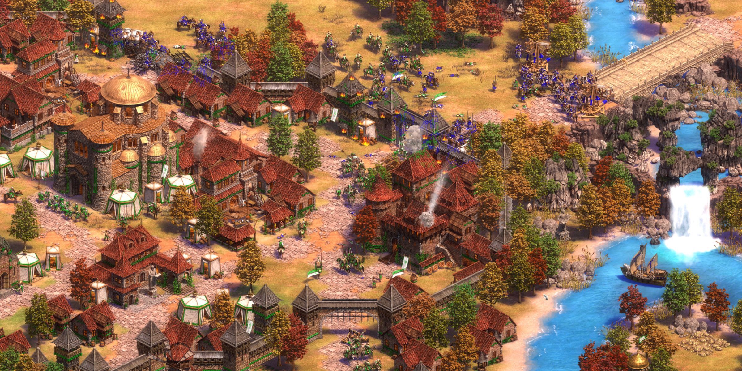 A Medieval Town Under Attack In Age Of Empires II: Definitive Edition.