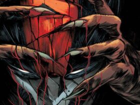 Ultimate Sabretooth's bloody hands holding Ultimate Wolverine's helmet