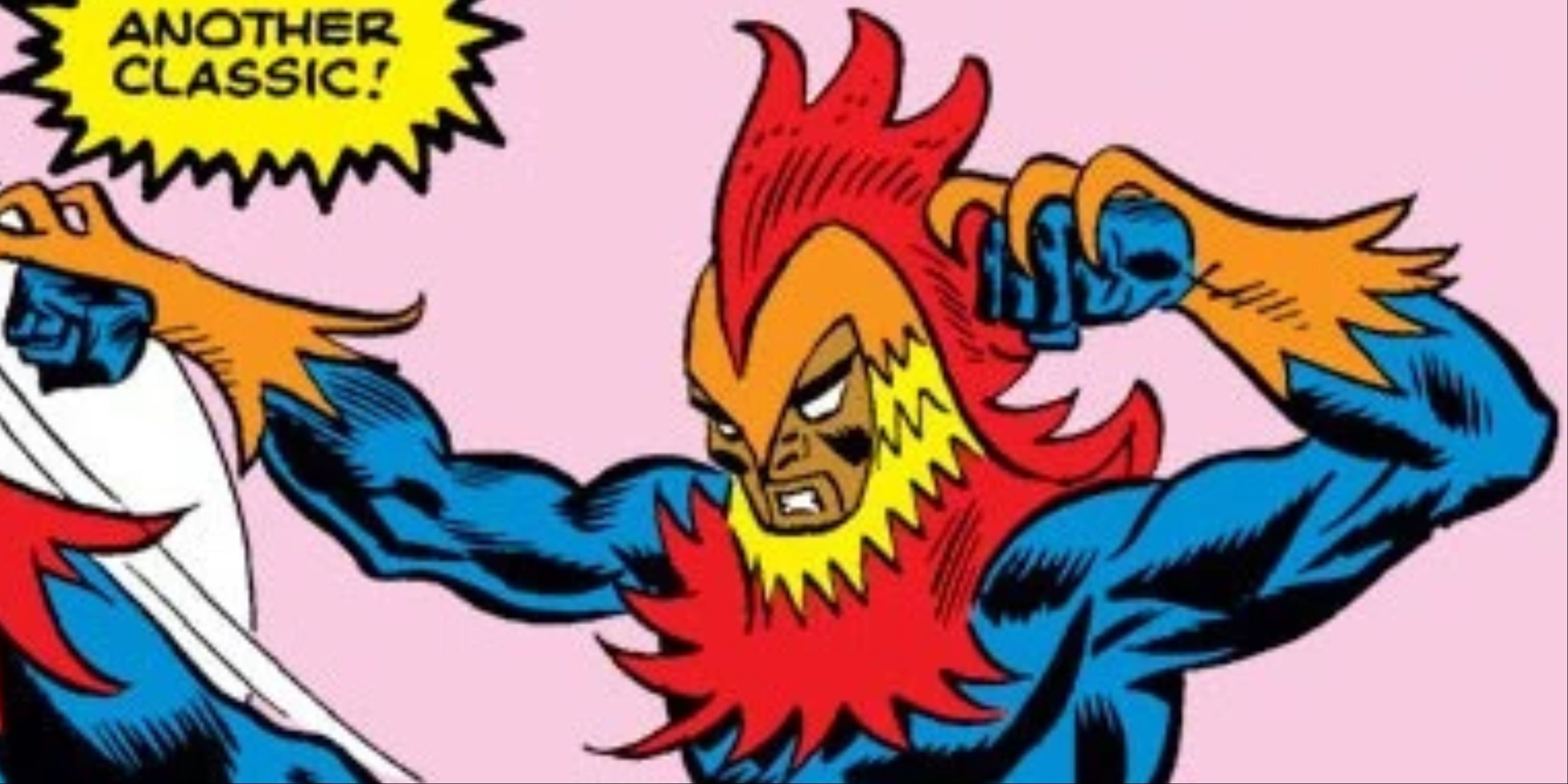 A man dressed in a blue, red, yellow and orange rooster costume with hooked claws curling over his fists.